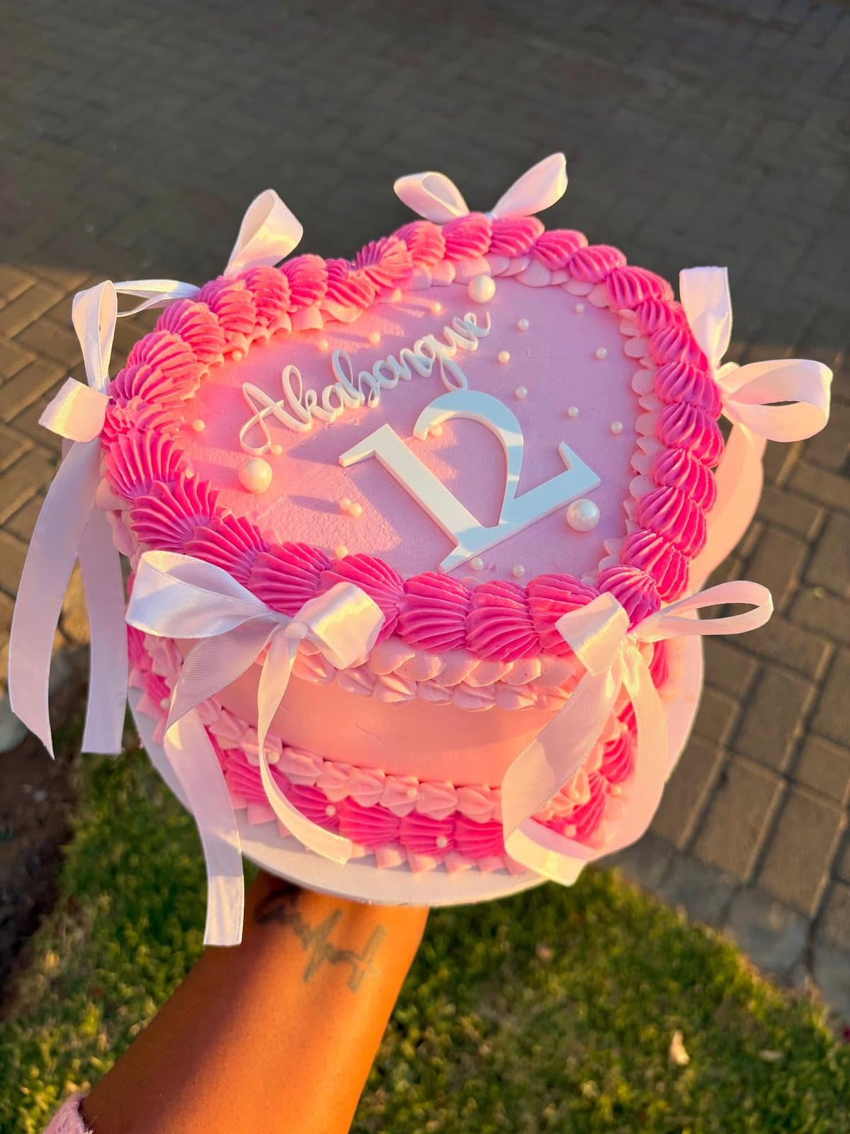Pink heart cake with Lambeth shell piping, satin ribbons and a number topper, by Baked by Mono