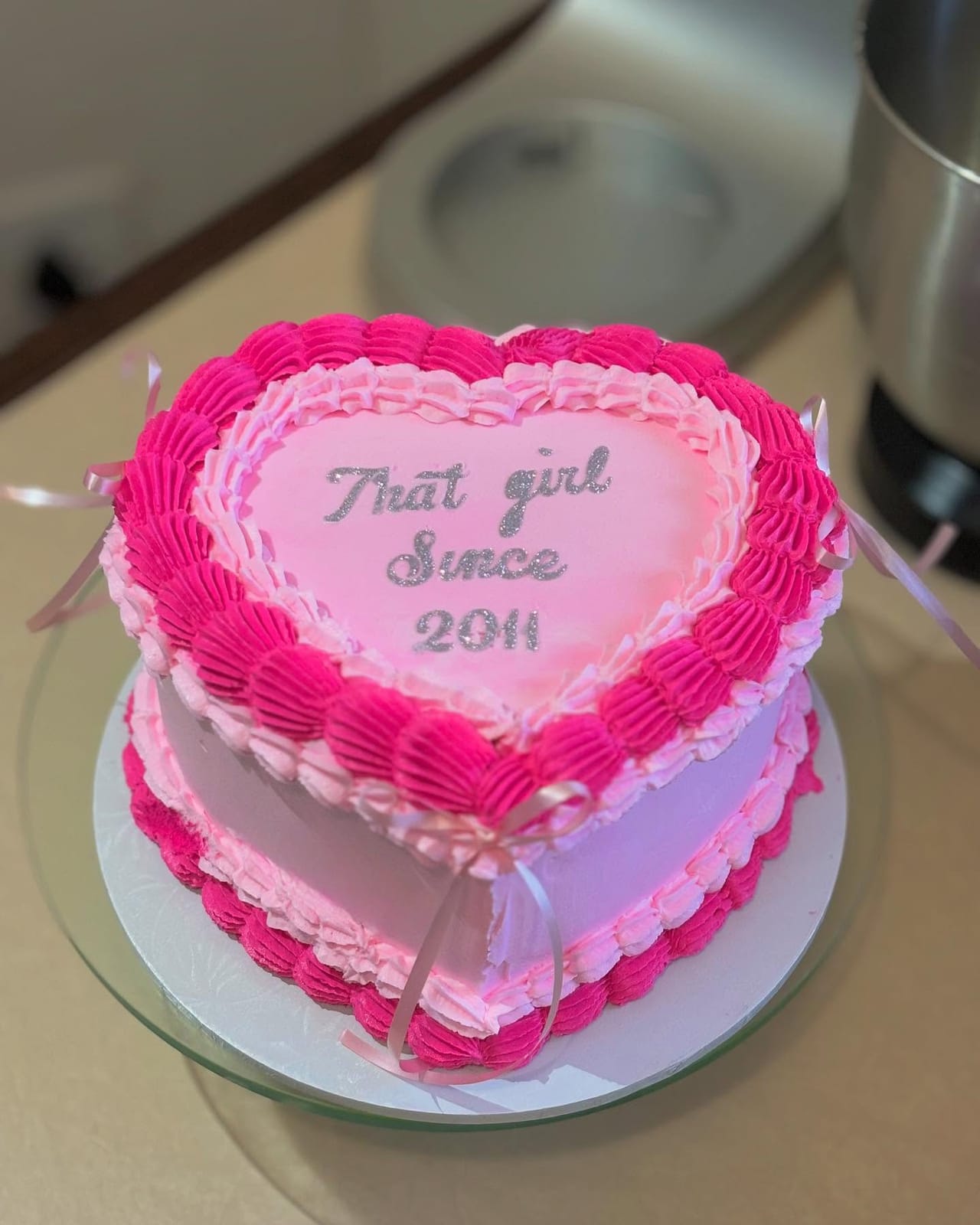 Pink heart cake with piped script lettering